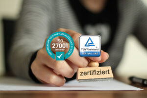 The picture shows the seal of approval from TÜV Rheinland for the ISO 27001 certification that nexnet has received.