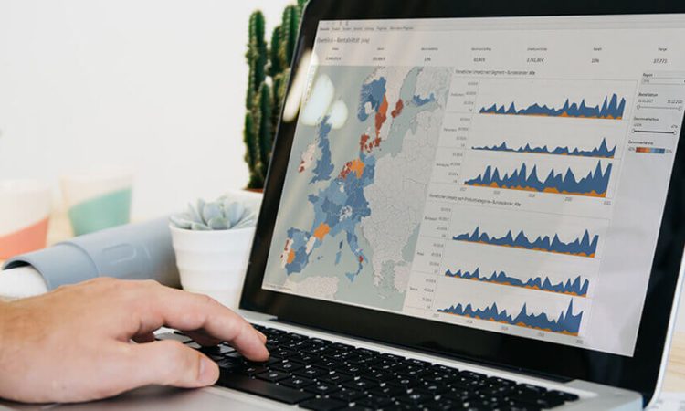 MRR reporting, left hand taps on laptop, graphic about reporting on screen