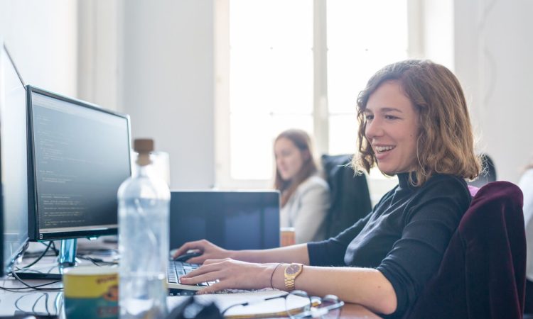 International Women's Day. The picture shows two women working in an office. They are working on IT-specific problems. Women in STEM professions are becoming increasingly common.