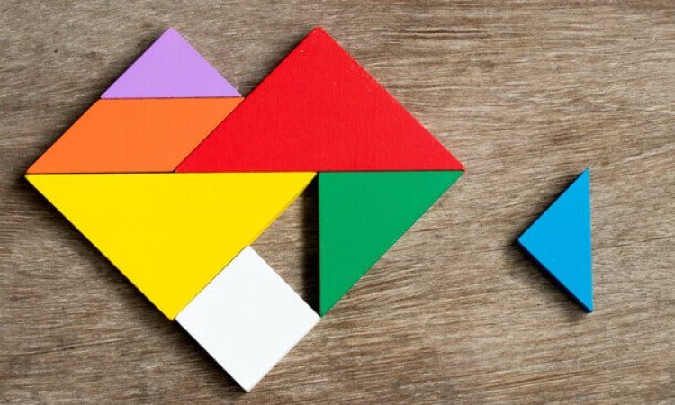 Colorful geometrically shaped building blocks are put together to form a heart.